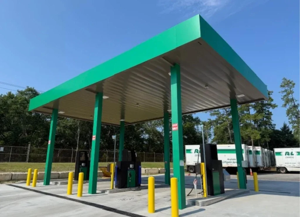 Completed fueling station canopy with fuel pumps built by Heartland Building Group
